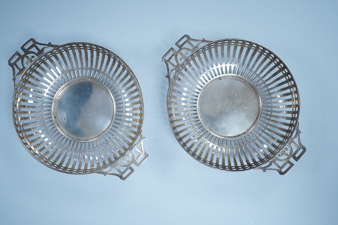 A pair of George V pierced silver two handled bonbon dishes, by Mappin & Webb, Birmingham, 1910, diameter 16.6cm over handles, possibly lacking glass inserts, 6.1oz.